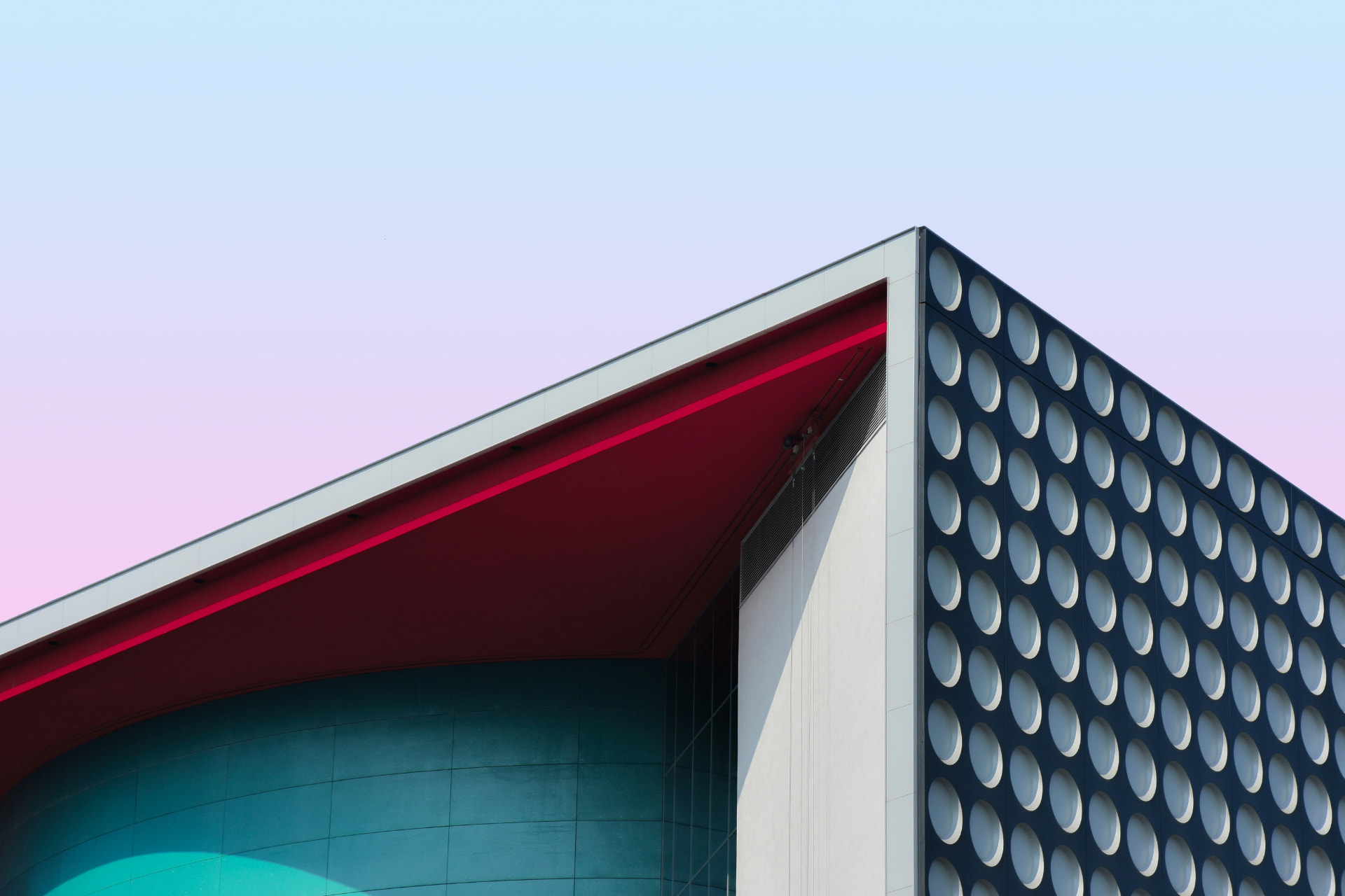 Modern architecture with a red roof and a patterned facade