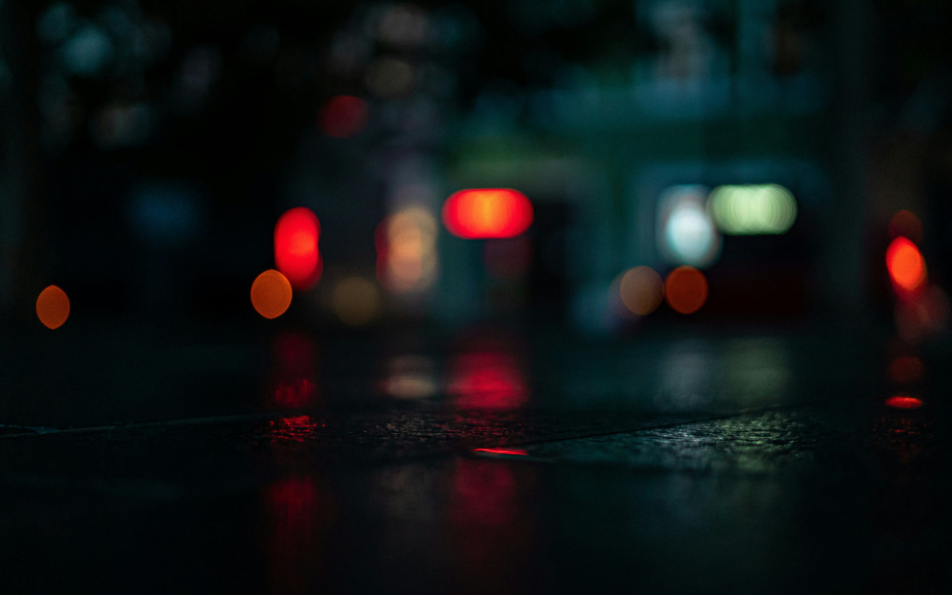 Blurred night city lights reflected on wet ground